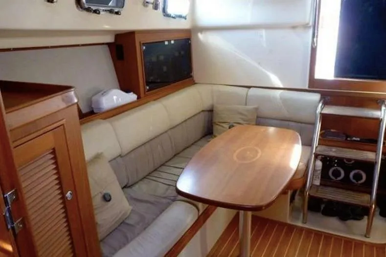 Navigator Yacht Photos Pics Interior of 2002 Island Packet Craft Express 360, featuring cozy seating and wooden table.