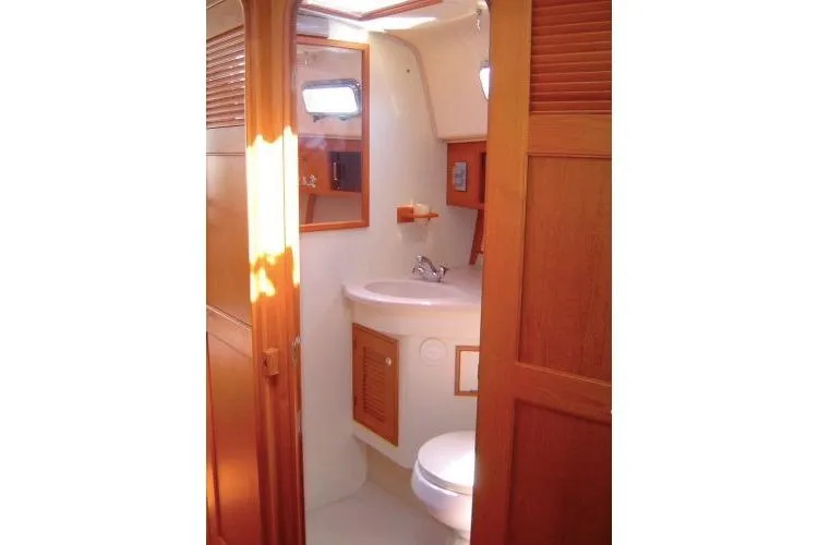Navigator Yacht Photos Pics 2002 Island Packet Packet Craft Express 360 bathroom with wooden cabinetry and compact design.