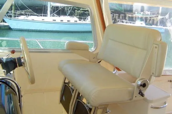 Navigator Yacht Photos Pics Captain's seat on 2002 Island Packet Packet Craft Express 360 yacht, with marina view.