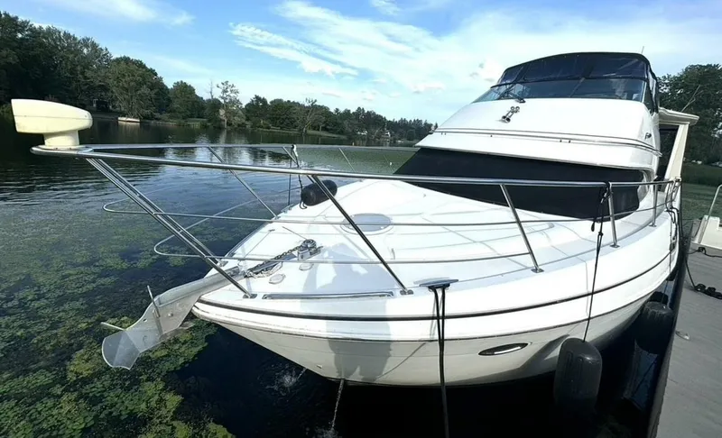  Yacht Photos Pics 2004 Carver 466 Motor Yacht docked on a serene lake.