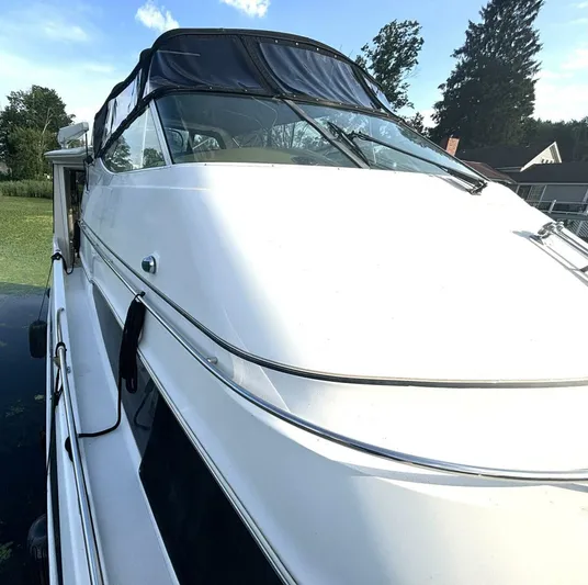  Yacht Photos Pics 2004 Carver 466 Motor Yacht with sleek design, docked near lush greenery.