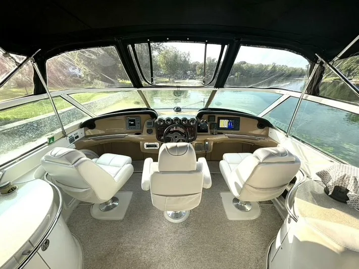  Yacht Photos Pics Interior view of 2004 Carver 466 Motor Yacht cockpit with luxurious seating and navigation controls.