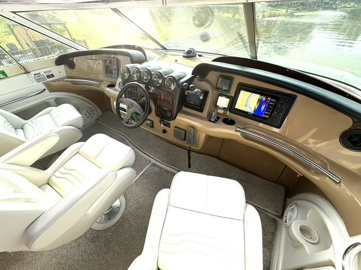  Yacht Photos Pics Interior of 2004 Carver 466 Motor Yacht helm with white seats and navigation equipment.