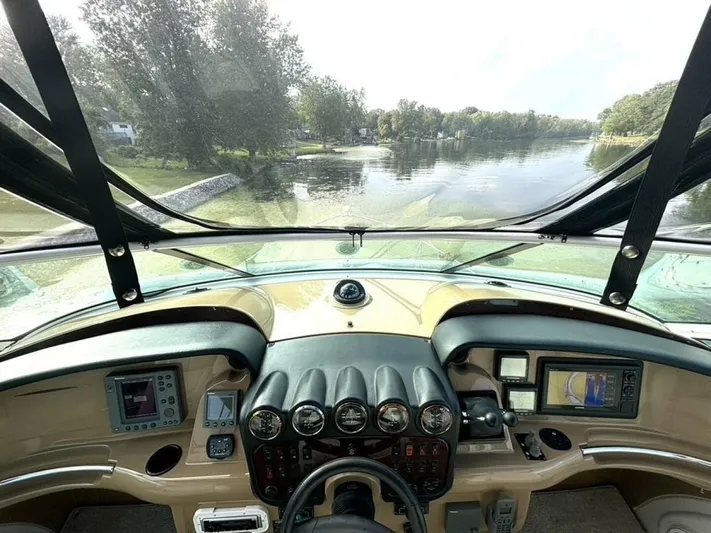  Yacht Photos Pics 2004 Carver 466 Motor Yacht helm with navigation instruments and scenic waterway view.