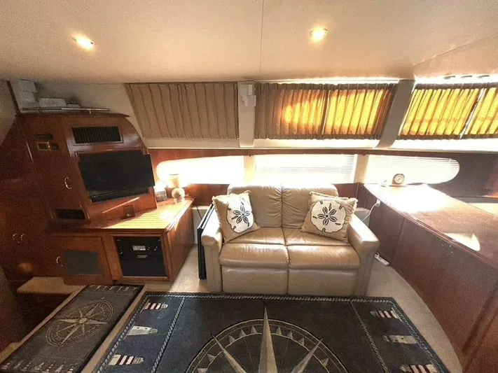  Yacht Photos Pics Luxurious interior of 2004 Carver 466 Motor Yacht with sofa, TV, and nautical decor.