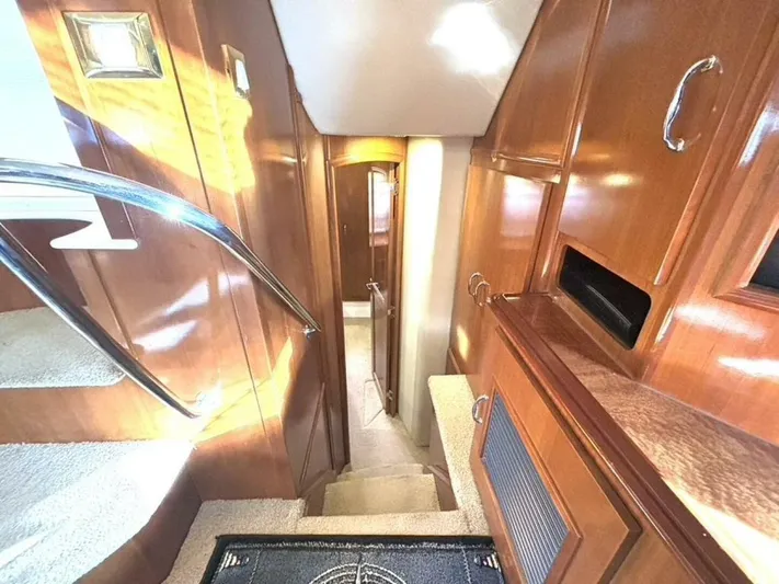  Yacht Photos Pics Interior of 2004 Carver 466 Motor Yacht with wooden cabinetry and carpeted stairs.