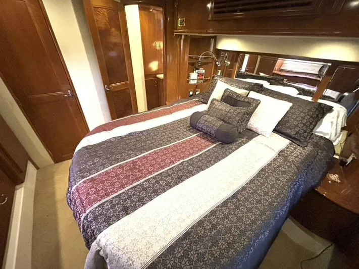  Yacht Photos Pics Luxurious bedroom interior of 2004 Carver 466 Motor Yacht with elegant bedding and wood finishes.