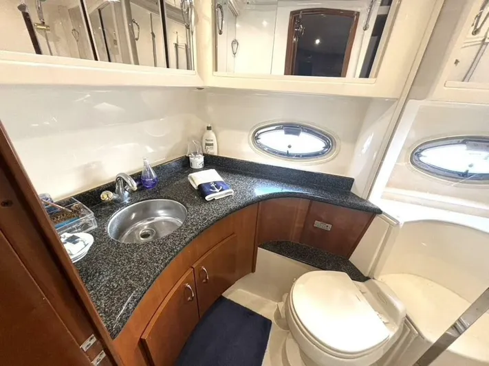  Yacht Photos Pics Luxurious bathroom in 2004 Carver 466 Motor Yacht with granite countertop and oval windows.