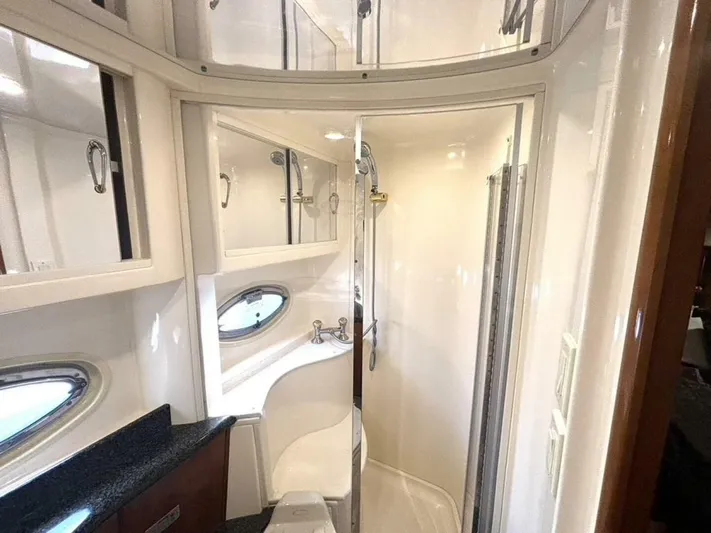  Yacht Photos Pics Luxurious bathroom in 2004 Carver 466 Motor Yacht with modern fixtures and porthole windows.