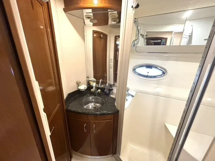  Yacht Photos Pics Luxurious bathroom in 2004 Carver 466 Motor Yacht with elegant fixtures and porthole window.