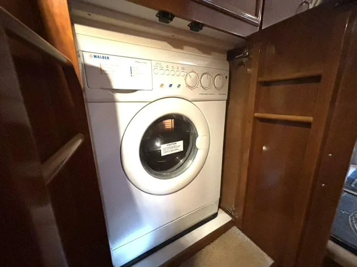  Yacht Photos Pics Washing machine inside 2004 Carver 466 Motor Yacht, wooden cabinet open.