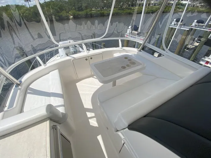  Yacht Photos Pics 2016 Riviera 43 Open Flybridge interior with seating and table, overlooking water.