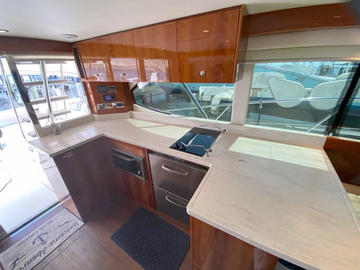  Yacht Photos Pics Modern kitchen area in 2016 Riviera 43 Open Flybridge yacht with marble countertops.