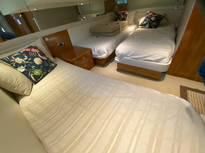  Yacht Photos Pics 2016 Riviera 43 Open Flybridge cabin with twin beds and floral pillows.