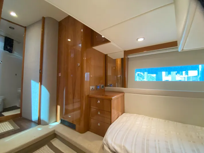  Yacht Photos Pics Luxurious bedroom interior of 2016 Riviera 43 Open Flybridge yacht with wooden cabinetry.