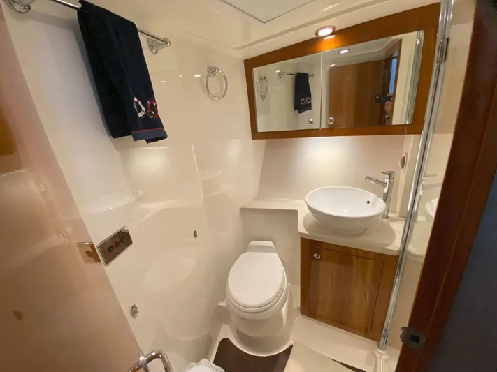  Yacht Photos Pics 2016 Riviera 43 Open Flybridge yacht bathroom with modern fixtures and wooden cabinetry.