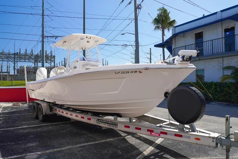  Yacht Photos Pics 2021 Blue Wave Boats Makaira on trailer, parked outdoors under clear sky.