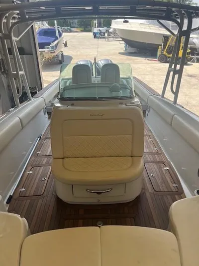  Yacht Photos Pics 2014 Chris-Craft Catalina 29 boat interior with elegant seating and wooden flooring.