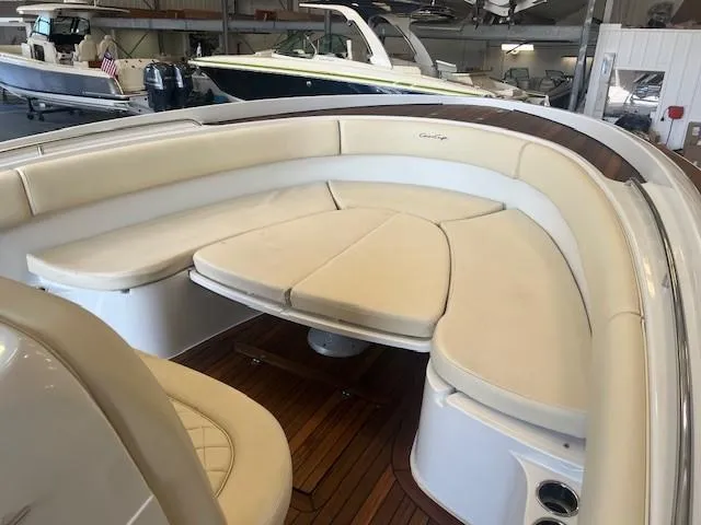  Yacht Photos Pics 2014 Chris-Craft Catalina 29 boat interior with cushioned seating and wooden flooring.