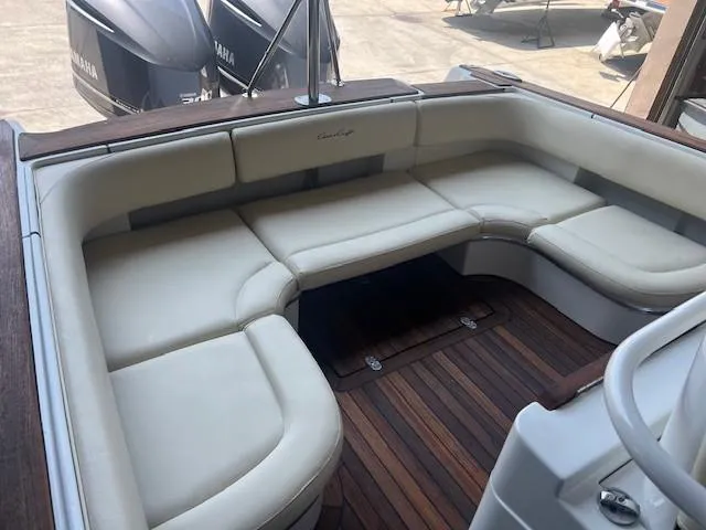  Yacht Photos Pics 2014 Chris-Craft Catalina 29 boat interior with cushioned seating and wooden flooring.