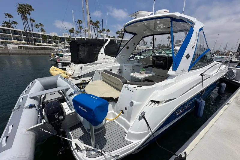 Relentless Yacht Photos Pics 2020 Monterey 355 Sport Yacht docked at marina with inflatable boat attached.
