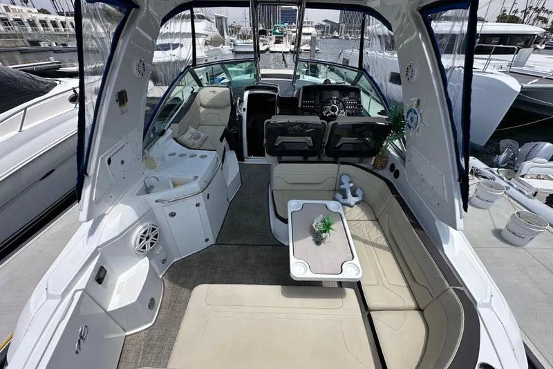 Relentless Yacht Photos Pics Luxurious 2020 Monterey 355 Sport Yacht interior with seating and helm, docked at marina.