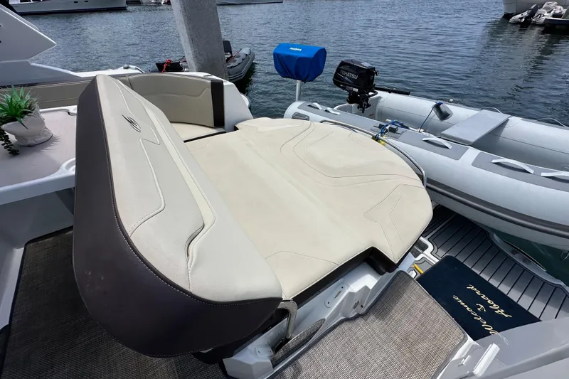 Relentless Yacht Photos Pics 2020 Monterey 355 Sport Yacht with seating area and inflatable boat at dock.