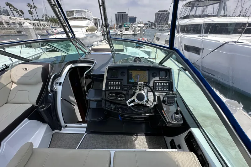 Relentless Yacht Photos Pics 2020 Monterey 355 Sport Yacht helm with modern controls and marina view.
