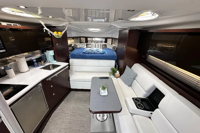 Relentless Yacht Photos Pics Luxurious interior of 2020 Monterey 355 Sport Yacht with modern kitchen and cozy seating.