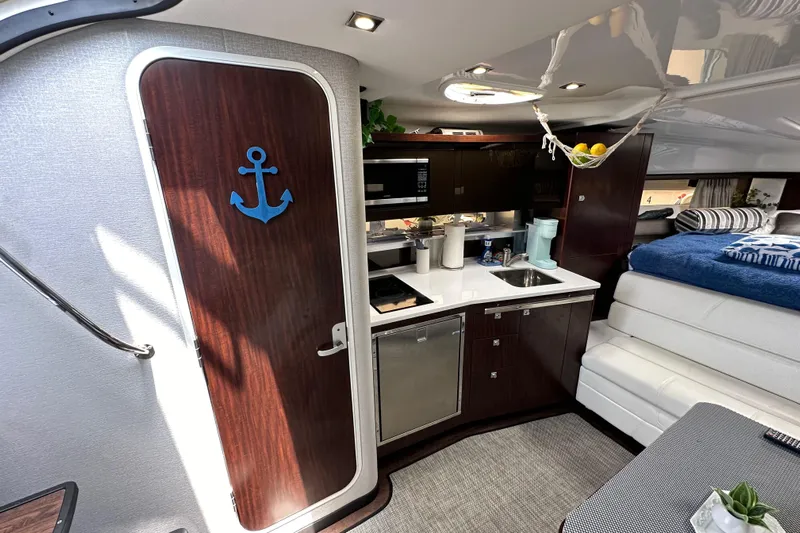 Relentless Yacht Photos Pics Interior of 2020 Monterey 355 Sport Yacht with kitchenette and cozy seating area.