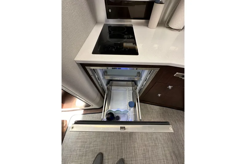 Relentless Yacht Photos Pics Modern kitchen area in 2020 Monterey 355 Sport Yacht with open drawer and cooktop.