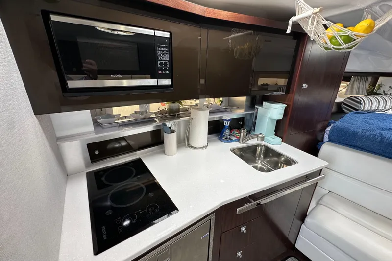 Relentless Yacht Photos Pics Modern kitchen in 2020 Monterey 355 Sport Yacht with microwave, stovetop, and sink.