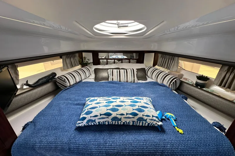 Relentless Yacht Photos Pics Luxurious interior of 2020 Monterey 355 Sport Yacht with cozy bedding and stylish decor.
