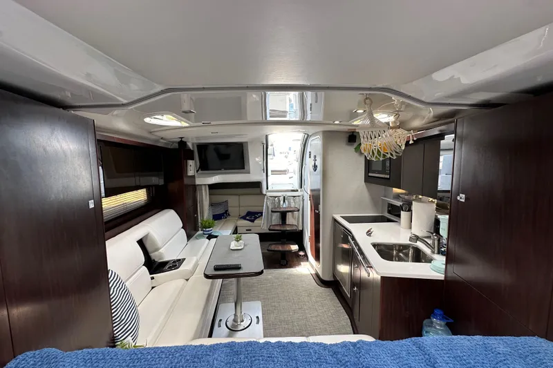 Relentless Yacht Photos Pics Interior of 2020 Monterey 355 Sport Yacht, featuring modern kitchen and cozy seating area.