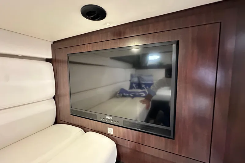 Relentless Yacht Photos Pics Interior of 2020 Monterey 355 Sport Yacht with wall-mounted TV and plush seating.