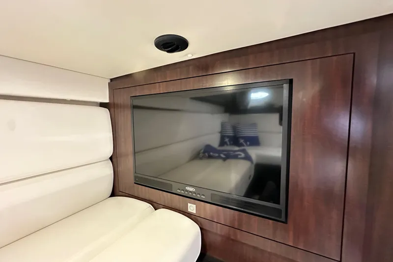 Relentless Yacht Photos Pics Interior of 2020 Monterey 355 Sport Yacht with TV and white seating.