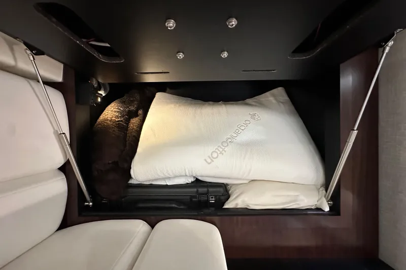 Relentless Yacht Photos Pics Under-seat storage in 2020 Monterey 355 Sport Yacht with pillows and blanket.