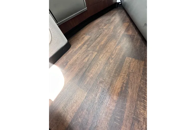 Relentless Yacht Photos Pics Wooden flooring inside a 2020 Monterey 355 Sport Yacht, showcasing elegant interior design.