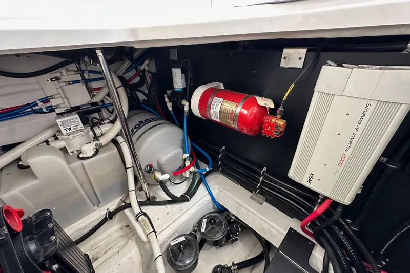 Relentless Yacht Photos Pics Engine compartment of 2020 Monterey 355 Sport Yacht with fire extinguisher and electrical components.