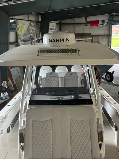 Fountain 34 Cc Yacht Photos Pics 2023 Fountain 34 CC boat with Garmin equipment, featuring luxurious seating in a garage.