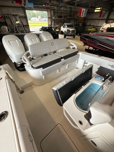 Fountain 34 Cc Yacht Photos Pics 2023 Fountain 34 CC boat interior with seating and storage in a garage setting.