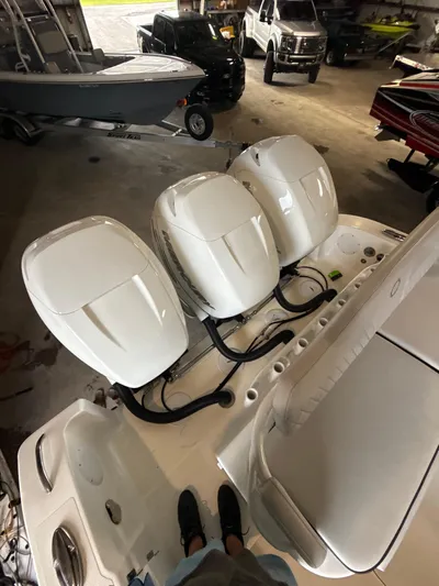 Fountain 34 Cc Yacht Photos Pics 2023 Fountain 34 CC boat with triple outboard engines in a garage setting.