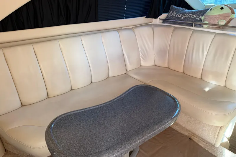  Yacht Photos Pics Luxurious interior of 1997 Sea Ray 370 Aft Cabin with plush seating and table.