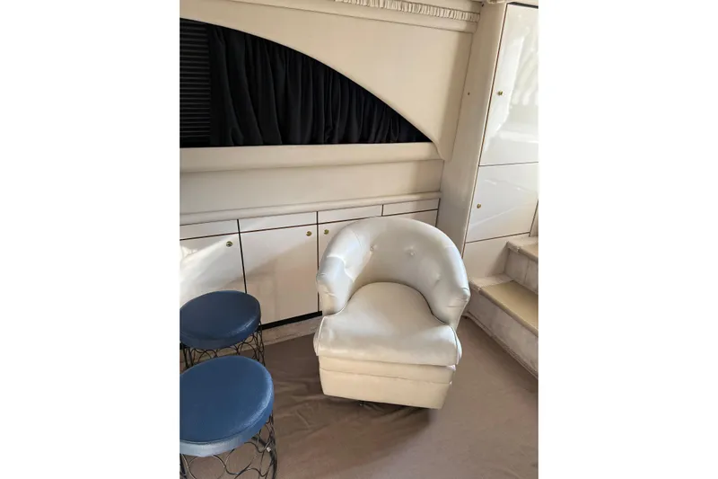  Yacht Photos Pics Interior of 1997 Sea Ray 370 Aft Cabin with white chair and blue stools.