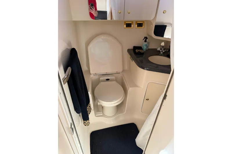  Yacht Photos Pics 1997 Sea Ray 370 Aft Cabin bathroom with toilet, sink, and storage cabinets.