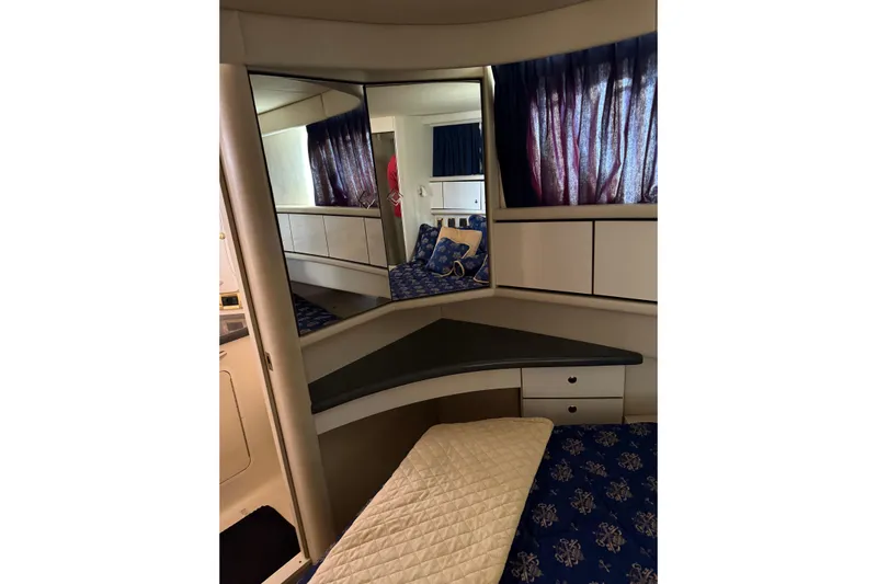  Yacht Photos Pics Interior of 1997 Sea Ray 370 Aft Cabin with mirrored vanity and blue curtains.