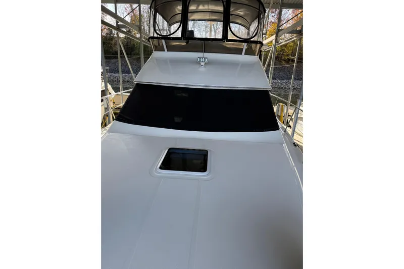  Yacht Photos Pics 1997 Sea Ray 370 Aft Cabin yacht with covered flybridge, docked in a marina.