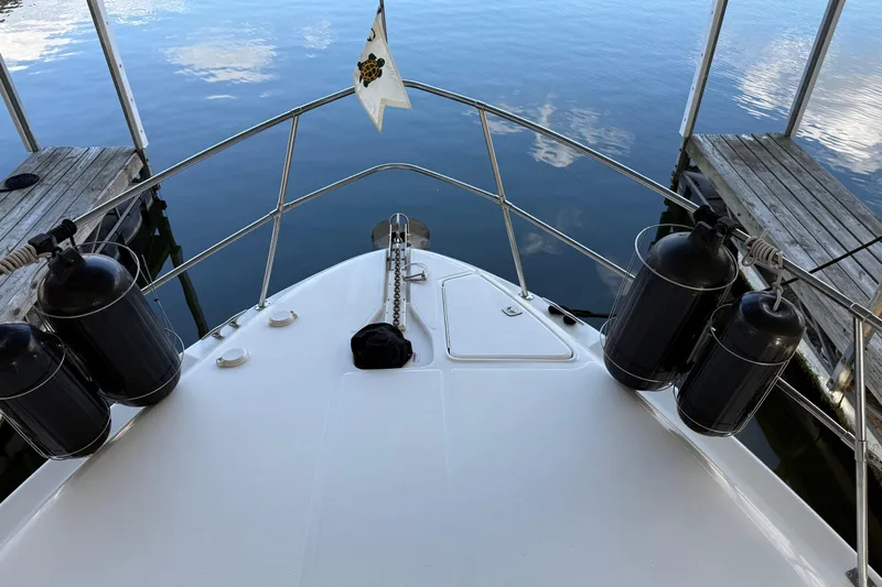  Yacht Photos Pics Bow view of 1997 Sea Ray 370 Aft Cabin docked, with fenders and calm water.
