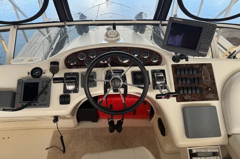  Yacht Photos Pics 1997 Sea Ray 370 Aft Cabin helm with steering wheel, gauges, and navigation equipment.