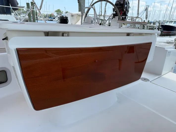 Passion Place Yacht Photos Pics Beneteau 49 (2007) cockpit with wooden hatch, marina background.